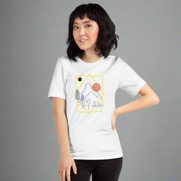 Woman wearing a white tshirt with a graphic for the IAABC Foundation Conference in Colorado Springs near the Garden of Gods. The visual depicts mountains and trees, a horse, dog, and cat in front.